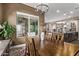 Bright dining room with a wooden table and kitchen access at 9814 W Rowel Rd, Peoria, AZ 85383