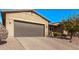 House exterior featuring a two-car garage and brick driveway at 9814 W Rowel Rd, Peoria, AZ 85383