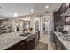 Island kitchen with stainless steel sink, pantry, and breakfast bar at 9814 W Rowel Rd, Peoria, AZ 85383