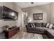 Comfortable living room with sectional sofa and large TV at 9814 W Rowel Rd, Peoria, AZ 85383