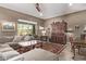Spacious living room with large sectional sofa, coffee table, and access to backyard at 9814 W Rowel Rd, Peoria, AZ 85383