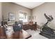 Home office with a large desk, elliptical machine, and plenty of workspace at 9814 W Rowel Rd, Peoria, AZ 85383