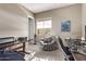 Spacious home office with a comfy chair, desk, and natural light at 9814 W Rowel Rd, Peoria, AZ 85383