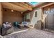 Covered patio with wicker furniture, creating a relaxing outdoor space at 9814 W Rowel Rd, Peoria, AZ 85383