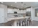 Elegant kitchen boasting white cabinets and a large kitchen island at 12145 W Briles Rd, Peoria, AZ 85383