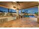 Outdoor kitchen area with built-in grill and dining space at 13167 N 104Th St, Scottsdale, AZ 85260