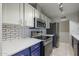 Modern kitchen with stainless steel appliances and white cabinets at 153 Laguna W Dr, Litchfield Park, AZ 85340