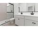 Modern bathroom featuring double sinks, black fixtures, and a glass enclosed shower at 16590 N Dante Way, Maricopa, AZ 85138