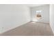 Empty bedroom with neutral carpet and window allowing natural light at 16590 N Dante Way, Maricopa, AZ 85138