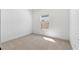 Bright, empty bedroom with neutral carpet and sunny window at 16590 N Dante Way, Maricopa, AZ 85138