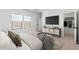 Bedroom with a large screen television and two bright windows at 16590 N Dante Way, Maricopa, AZ 85138