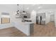 Spacious kitchen featuring gray cabinets, stainless appliances, and wood-look tile flooring at 16590 N Dante Way, Maricopa, AZ 85138