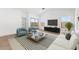 Bright living room featuring modern furniture, tile floors and neutral walls at 16590 N Dante Way, Maricopa, AZ 85138
