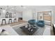 Bright living room with modern decor, eat-in kitchen, and sliding glass doors at 16590 N Dante Way, Maricopa, AZ 85138