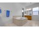 Bathroom boasts a large soaking tub and double vanity at 4219 N 161St Ave, Goodyear, AZ 85395