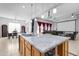 Granite kitchen island with sink and seating area at 4219 N 161St Ave, Goodyear, AZ 85395