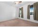 Bright bedroom with carpet, ceiling fan, and two windows with curtains at 4435 N Presidio Dr, Florence, AZ 85132