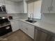 Updated kitchen with quartz countertops, stainless steel appliances, and new faucet and fixtures at 4643 W Laurel Ln, Glendale, AZ 85304