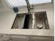 Modern kitchen sink with stainless steel fixtures and white marble countertop under a window at 4643 W Laurel Ln, Glendale, AZ 85304