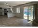 Open-concept living area with a sliding glass door offering backyard pool views and natural light at 4643 W Laurel Ln, Glendale, AZ 85304