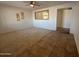 Inviting living area featuring neutral paint, plush carpeting, and stylish tile flooring at 4643 W Laurel Ln, Glendale, AZ 85304