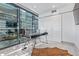 Modern home office features a glass desk, large windows, and a stylish barn door at 7120 E Kierland Blvd # 307, Scottsdale, AZ 85254