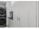 Laundry room with modern washer, dryer, and cabinetry at 7120 E Kierland Blvd # 307, Scottsdale, AZ 85254