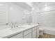 Modern bathroom with double sinks, white countertops and cabinets, with a shower-tub combination at 7396 W Whitehorn Trl, Peoria, AZ 85383