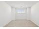 Bright bedroom featuring neutral carpet, a window letting in natural light, and fresh white walls at 7396 W Whitehorn Trl, Peoria, AZ 85383