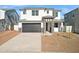 Inviting two-story home featuring a two-car garage and decorative stone accents enhancing the facade and entryway at 7396 W Whitehorn Trl, Peoria, AZ 85383
