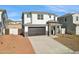 Charming two-story home with a two-car garage and stone accents enhancing curb appeal under a clear blue sky at 7396 W Whitehorn Trl, Peoria, AZ 85383