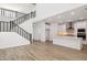 Open-concept kitchen and living area, featuring a modern staircase and a central island with stylish countertops at 7396 W Whitehorn Trl, Peoria, AZ 85383