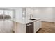 Modern kitchen island with white cabinets and quartz countertops at 7446 W Whitehorn Trl, Peoria, AZ 85383