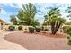 Spacious backyard with gravel and mature landscaping at 9405 E Cherrywood Dr, Sun Lakes, AZ 85248