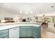Open kitchen with a large island, light green cabinets, and views to Gathering room at 9405 E Cherrywood Dr, Sun Lakes, AZ 85248