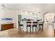 Modern kitchen with a breakfast bar, light cabinets, and tile floors at 9405 E Cherrywood Dr, Sun Lakes, AZ 85248