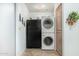 Stackable washer and dryer in a small laundry room at 9405 E Cherrywood Dr, Sun Lakes, AZ 85248