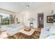 Spacious living room featuring neutral colored sofas and a ceiling fan at 9405 E Cherrywood Dr, Sun Lakes, AZ 85248