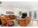 Relaxing living room with brown sectional sofa and a large TV at 9405 E Cherrywood Dr, Sun Lakes, AZ 85248