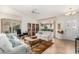 Bright living room with comfy sofas, a coffee table, and large windows at 9405 E Cherrywood Dr, Sun Lakes, AZ 85248