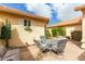 Private patio with seating area and lush desert plants at 9405 E Cherrywood Dr, Sun Lakes, AZ 85248
