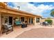 Covered patio with seating area, fire pit, and desert landscaping at 9405 E Cherrywood Dr, Sun Lakes, AZ 85248