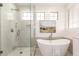 Luxury bathroom with free-standing tub, glass shower, and neutral color palette at 135 E Julian Dr, Gilbert, AZ 85295