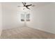 Bright carpeted bedroom featuring a ceiling fan and two windows at 135 E Julian Dr, Gilbert, AZ 85295