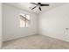 Bright carpeted bedroom featuring a window with blinds and a ceiling fan at 135 E Julian Dr, Gilbert, AZ 85295