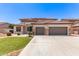 Charming two-story home boasts a three-car garage, well-manicured lawn, and beautiful desert landscaping at 135 E Julian Dr, Gilbert, AZ 85295
