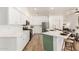 Spacious kitchen features stainless appliances, white cabinets and a large island with seating at 135 E Julian Dr, Gilbert, AZ 85295