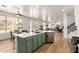 Open-concept kitchen featuring an island with bar seating and view of the backyard and living room at 135 E Julian Dr, Gilbert, AZ 85295