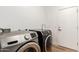 Clean laundry room featuring modern washer and dryer units and a utility sink at 135 E Julian Dr, Gilbert, AZ 85295