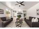 Bright living room with large window, fireplace, and cozy seating area; perfect for relaxation at 135 E Julian Dr, Gilbert, AZ 85295